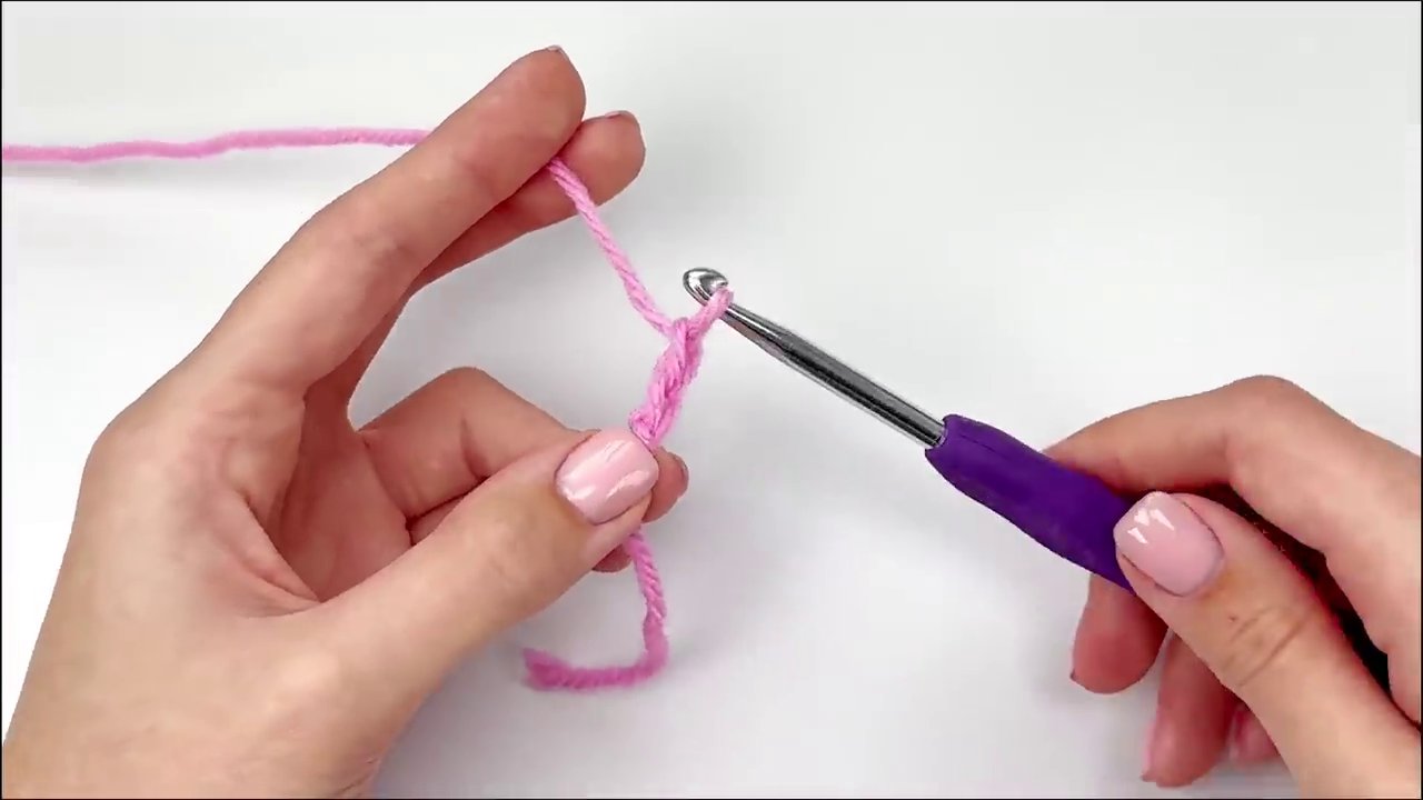 The hook is inserted into the center ring, ready to create the first set of double crochets.