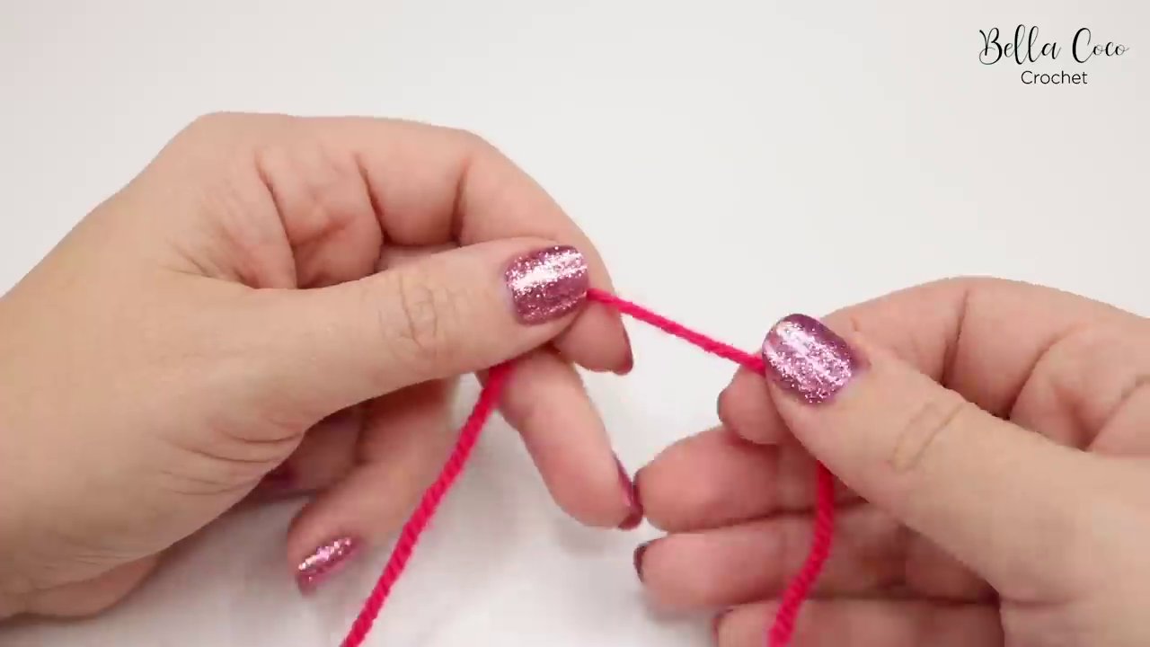 A hand demonstrating the final step of forming a slip knot, showing the loop ready for the hook.