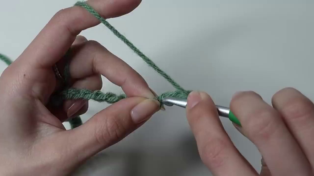 The hook inserting into the small, tightened chain to begin the first set of double crochets.