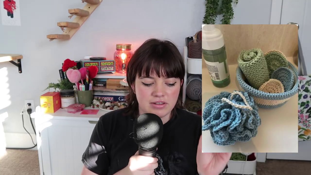 A small crocheted basket filled with round face scrubbies sits next to skincare bottles.