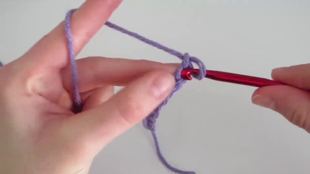 The hook is inserted into the second chain, demonstrating where to place the first single crochet stitch.