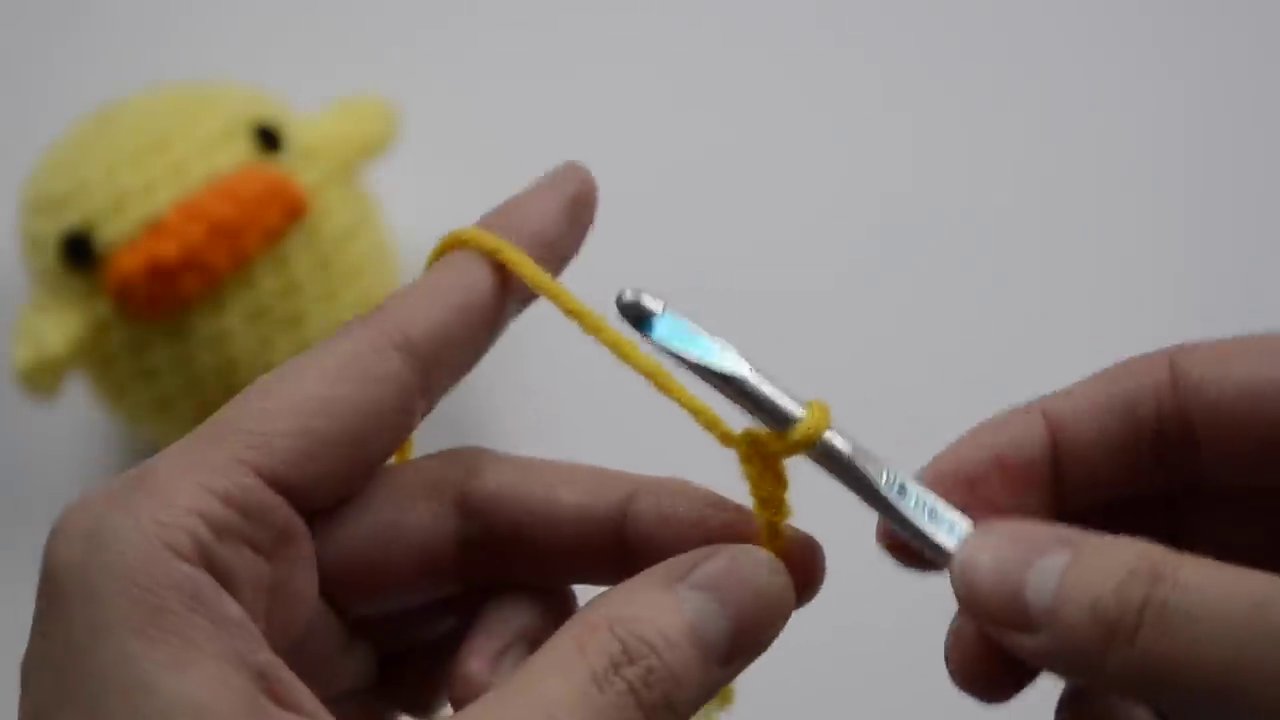 The action of completing a chain stitch, pulling the yarn through the loop on the hook.