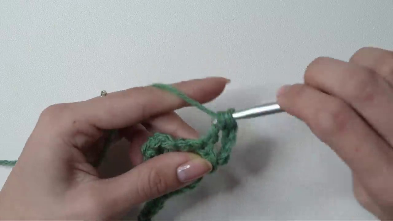 The final step of the dc3tog, pulling yarn through the last four loops to form the pointed end.