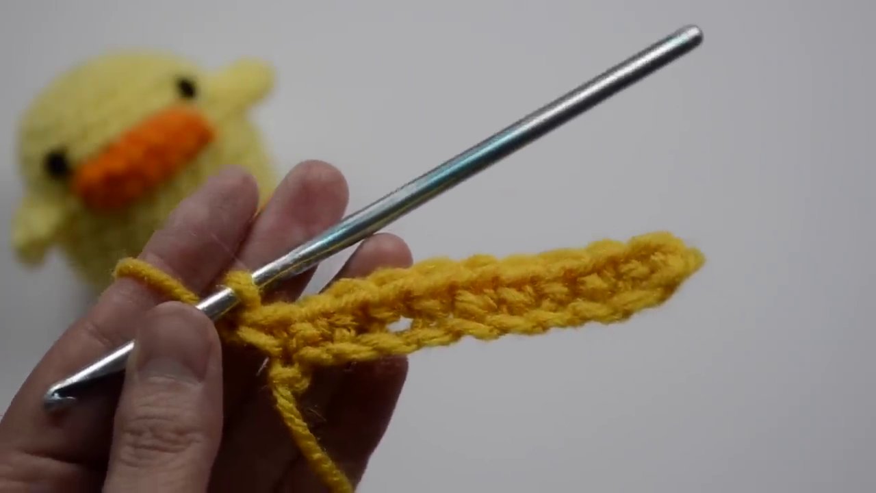 Turning the crochet work after completing a turning chain, ready to begin the next row.