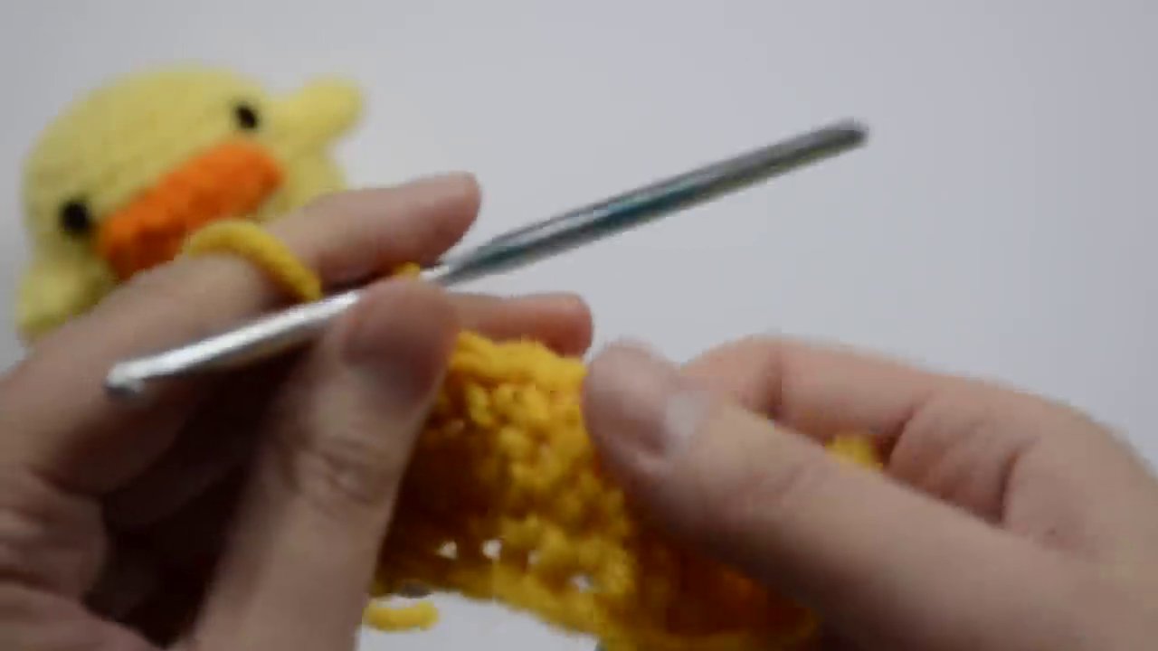 A completed three-row swatch of single crochet stitches, showing the neat, textured fabric it creates.