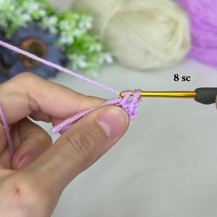 A close-up of the purple center, showing even stitches and consistent tension as the motif begins to take shape.