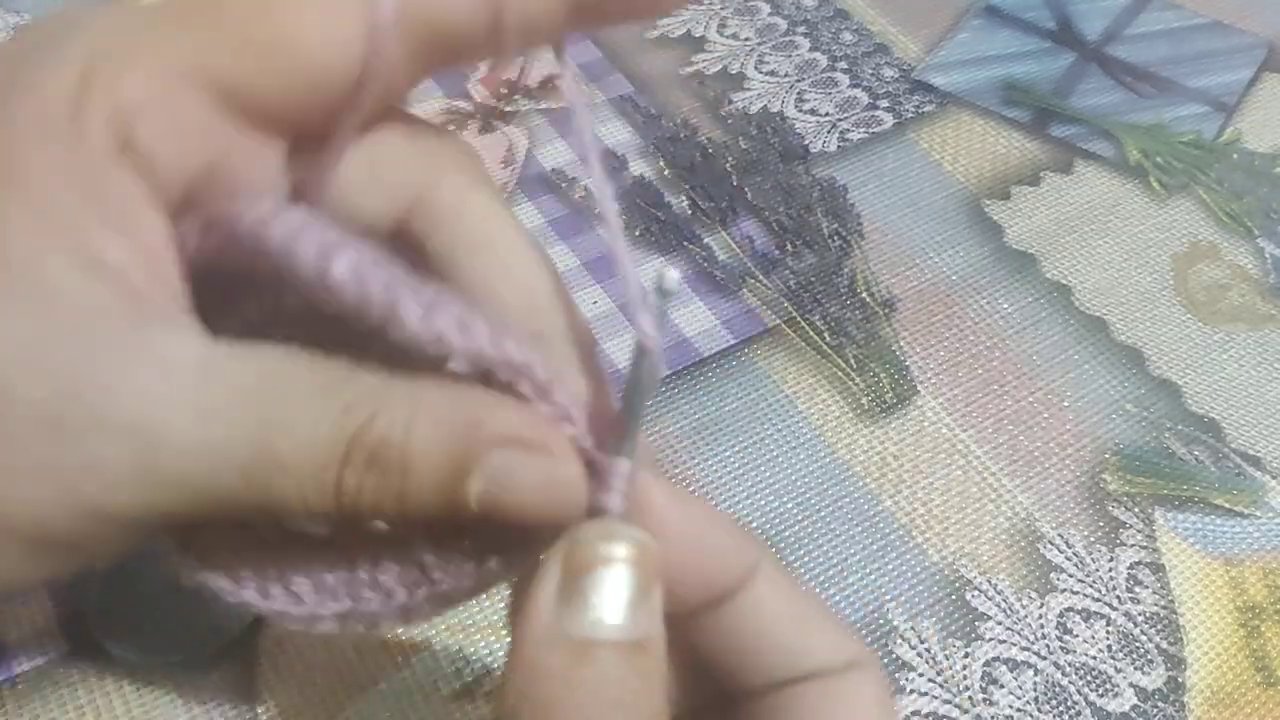 The fabric beginning to take shape with alternating double crochet clusters and chain spaces.