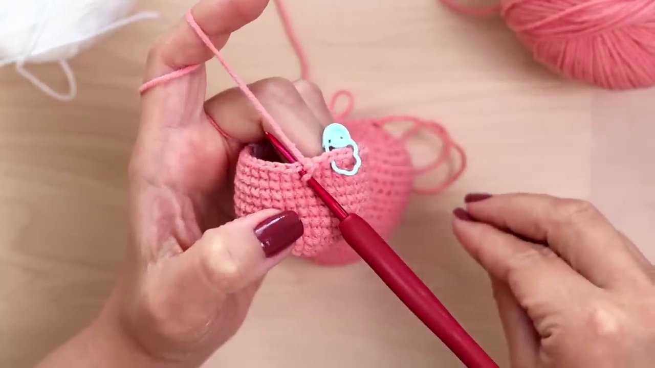 Close-up of a single crochet stitch showing the X-shape created by the yarn under method.