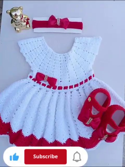 A Minnie Mouse-inspired crochet outfit arranged on a wooden surface.