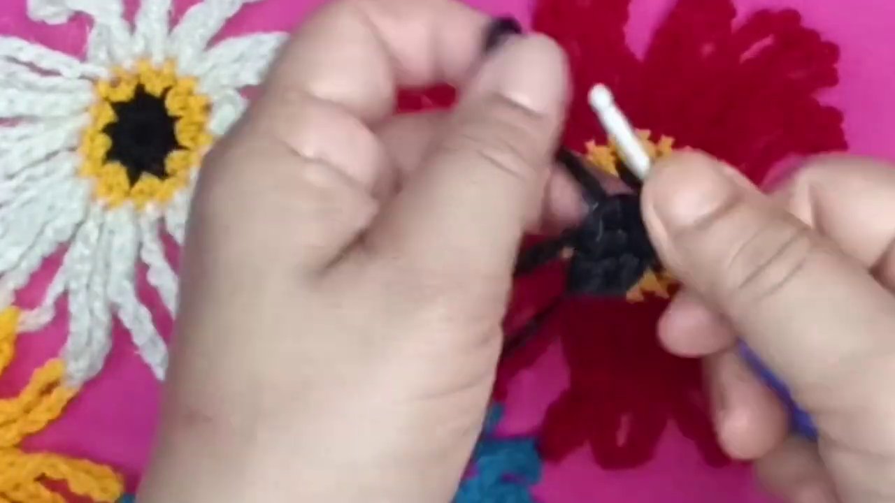 A side-angle view of the crochet hook and hands, showing the stitching process from a new perspective.