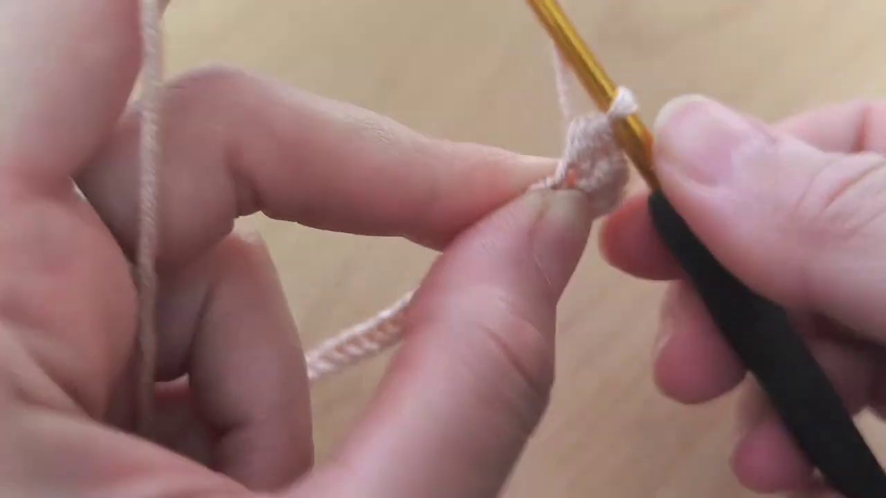 The hook pulls through all three loops in one smooth motion, completing the stitch.