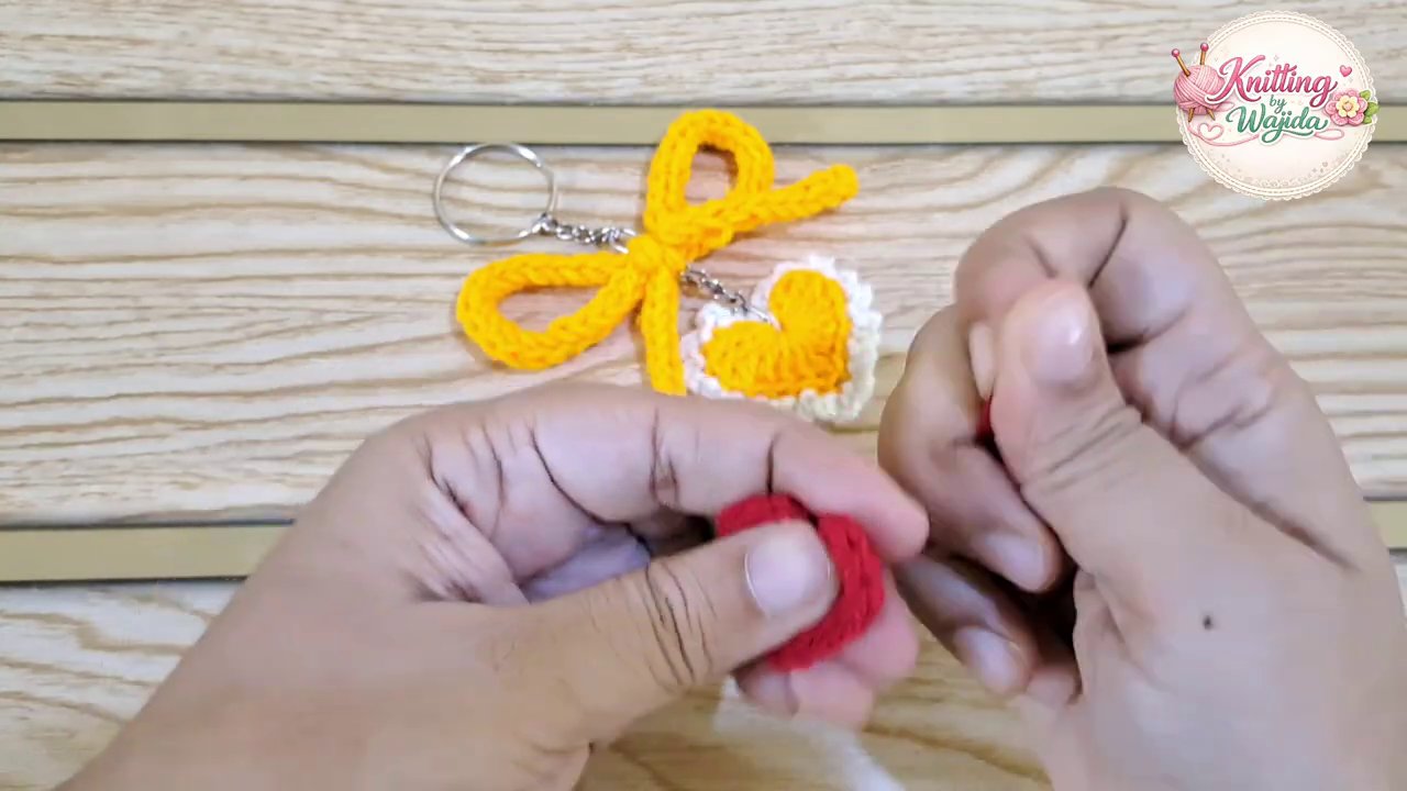 The finished heart keychain with a white border and a silver keychain ring attached at the top.