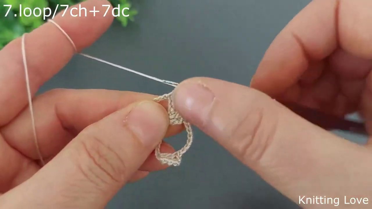 A single double crochet being worked, with the hook positioned at the top of a chain space.