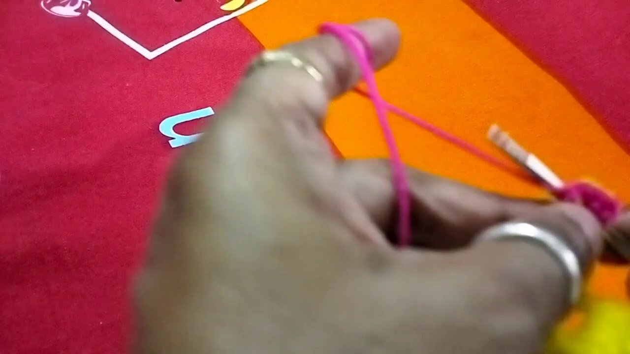 Completed poshak held open to show the full shape, with the shell border visible at the hem.