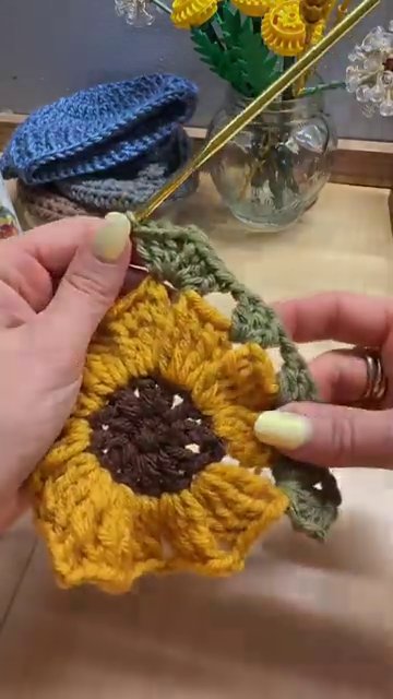 Multiple sunflower granny squares stacked and ready to be joined into a blanket.