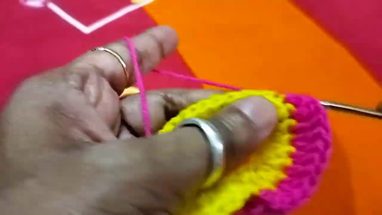 The poshak lying flat on the red fabric, showing the even stripes and neat edges.