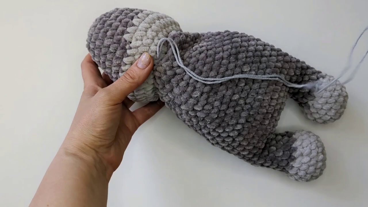 A collection of finished chenille amigurumi — a bear, a bunny, and a simple round creature — showing the soft, fuzzy finish.