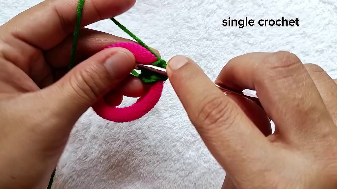 Inserting the hook through the elastic and pulling up the first loop of yarn.