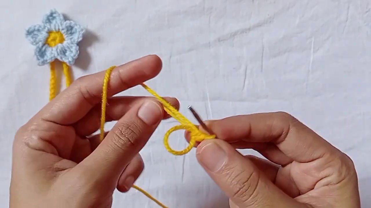 Close-up of the magic ring with four chain loops spread evenly around the center.