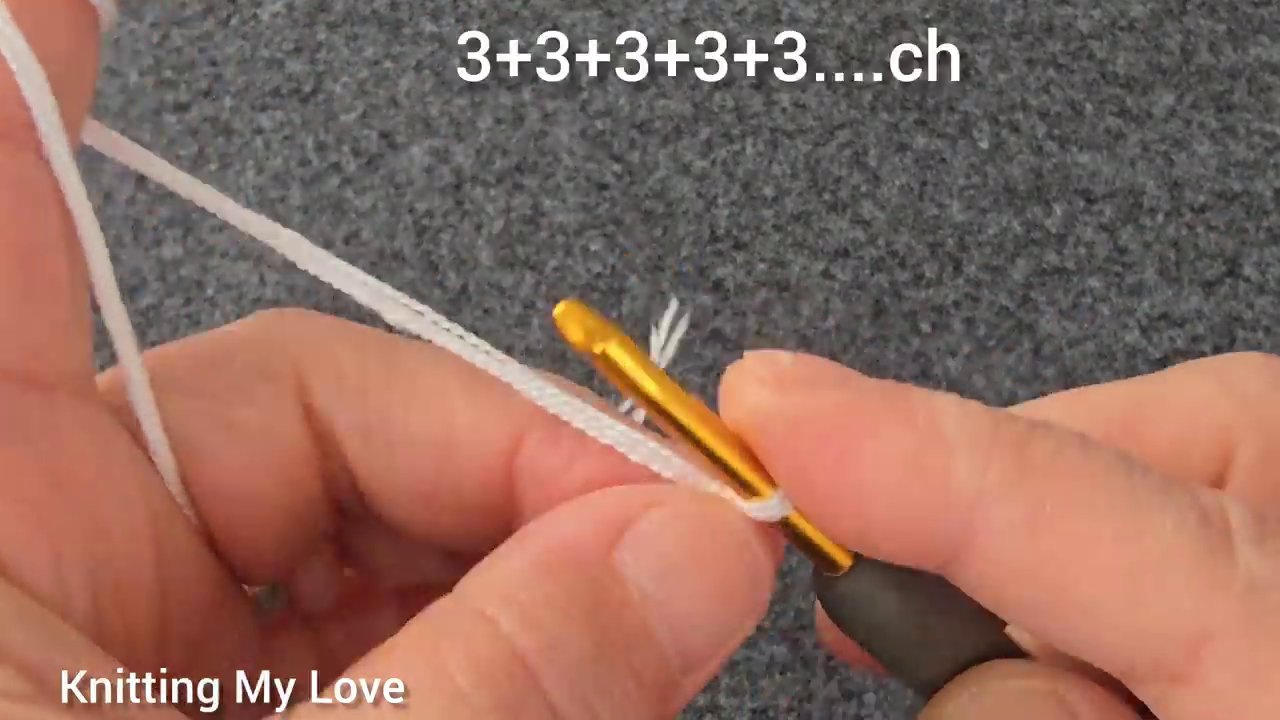 Close-up of the hook working a double treble stitch into the fabric.