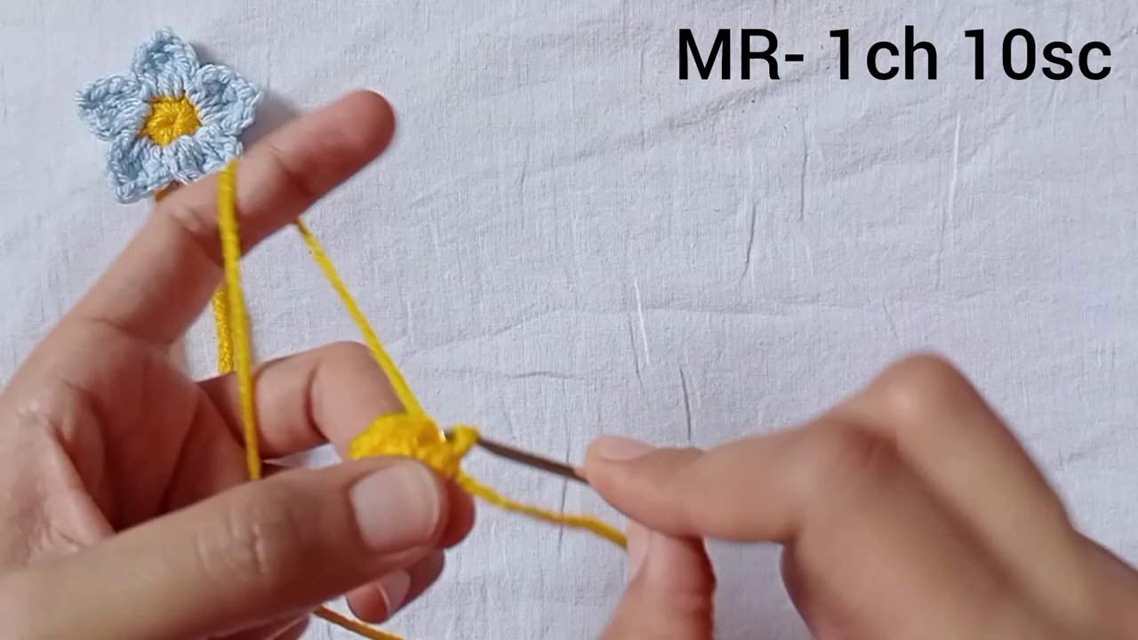 The flower turned over, showing the chain loops worked behind the first petal layer.