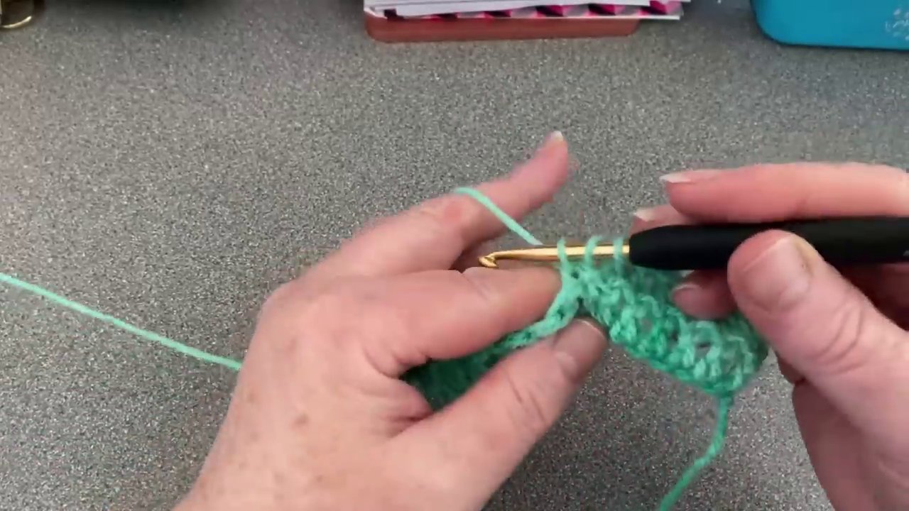 The finished first stitch of the row, showing the extra loop worked into the side to bring it to full height.