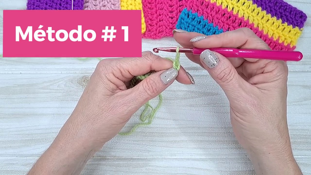 A close-up of the hook being twisted before insertion into the stitch.