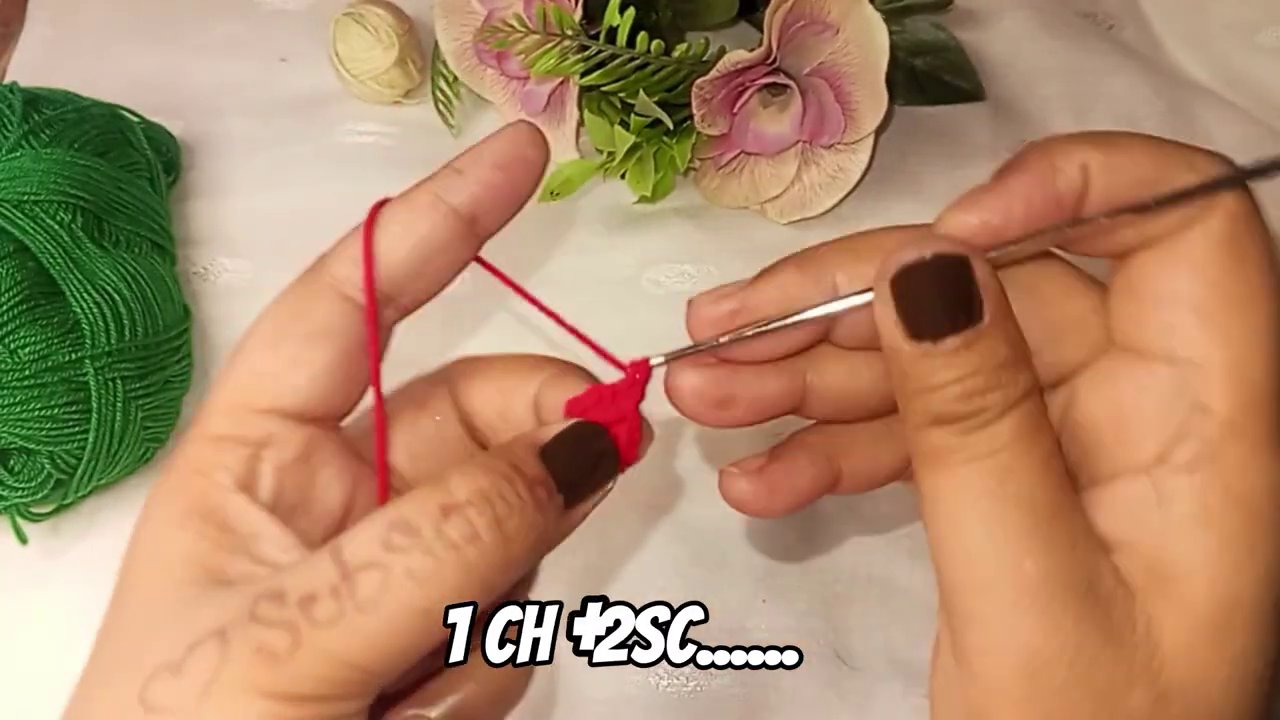 Close-up of the color change between red and green yarn, showing clean stitches.