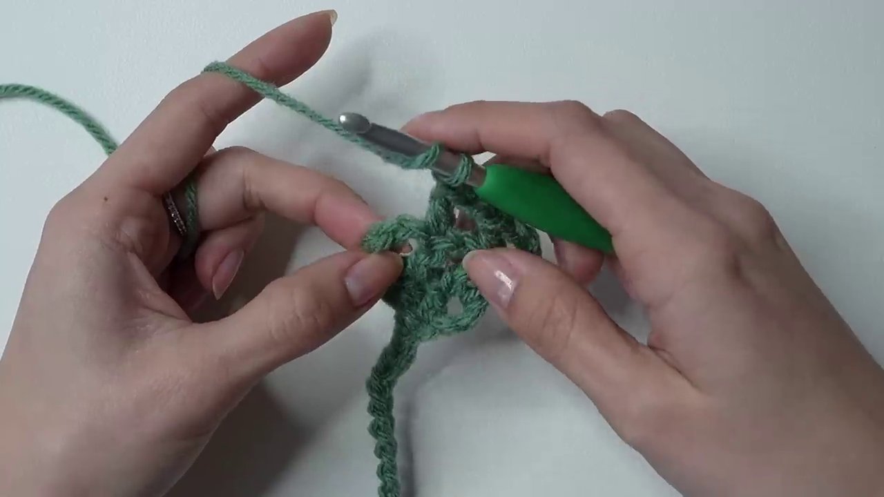 The finished hairband tied on a head form, showing how the mesh sits across the crown.