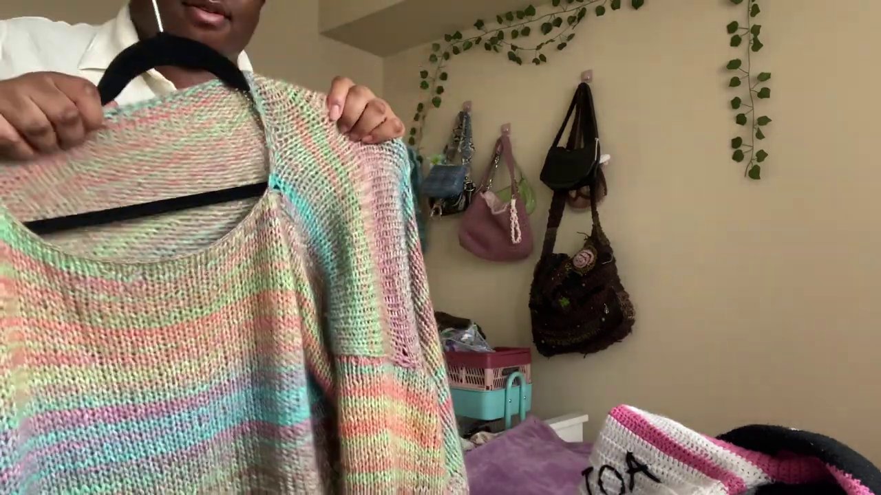 A finished tapestry crochet cardigan laid flat showing the full-color graphic design across both panels.