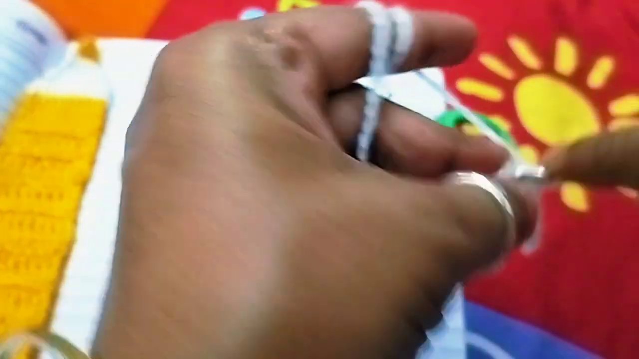 Hands holding the finished bookmark up to the camera, showing both sides.