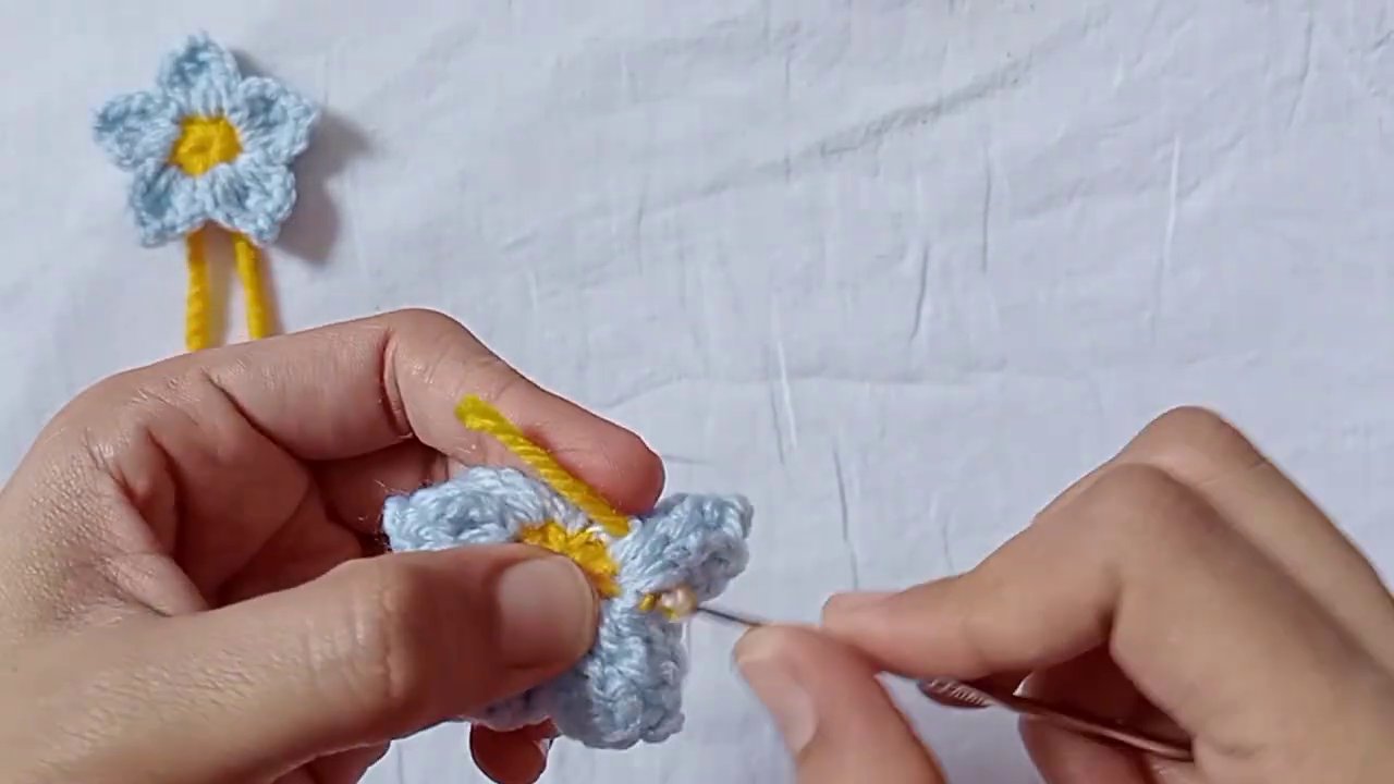 Three variations of the flower: one solid color, one with contrasting back petals, and one with beads in the center.