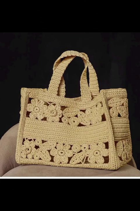 A lace-weight shawl laid flat, showing the geometric openwork pattern.