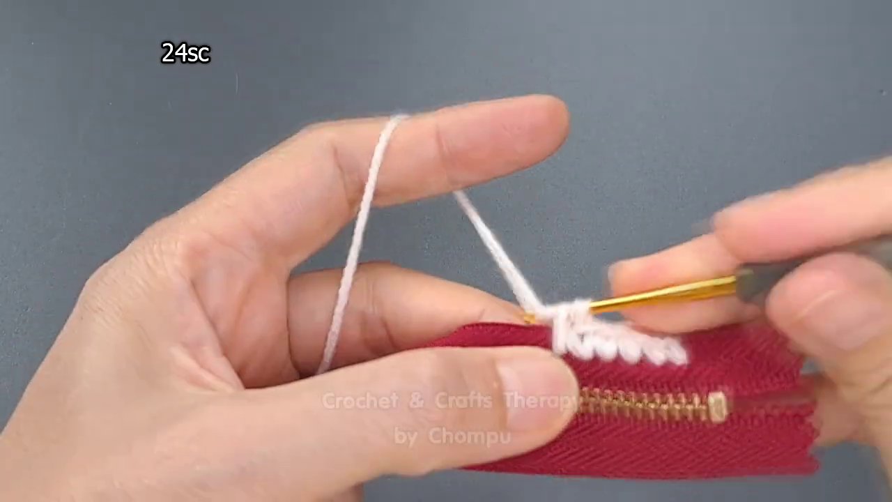 The crocheted fabric beginning to curve upward, forming the walls of the purse.