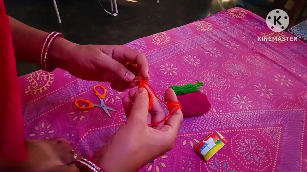 Close-up of the crochet hook working a vein stitch down the center of the leaf.
