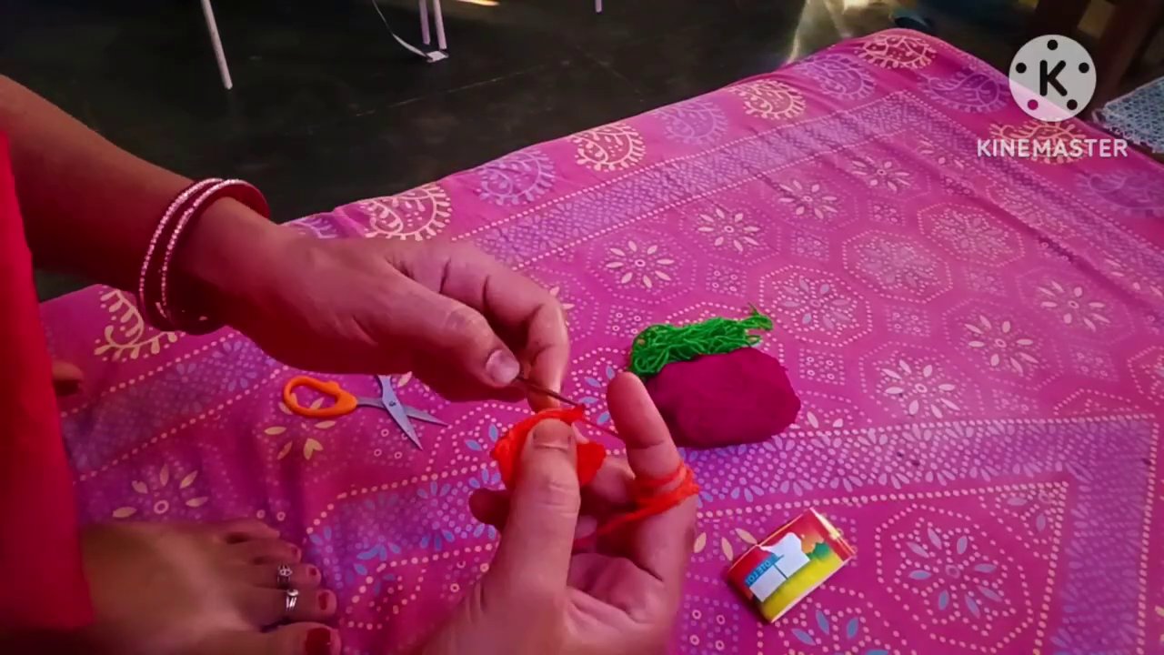 A small collection of completed leaves in different colors arranged on the pink fabric.