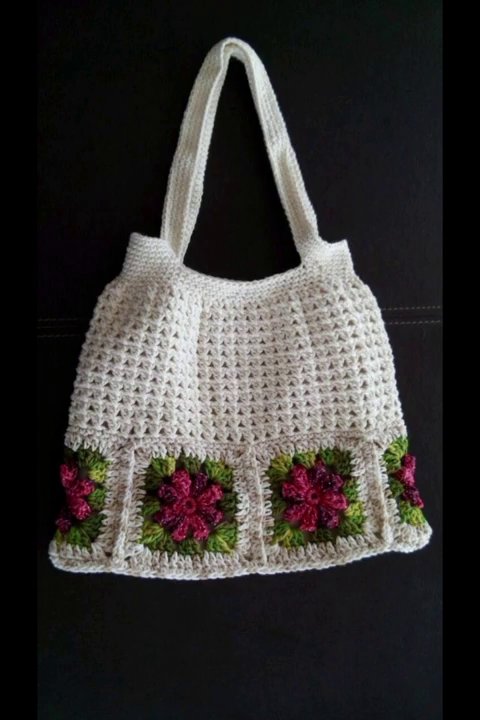 A crochet piece pinned to a blocking mat, with the stitches visibly opening up.