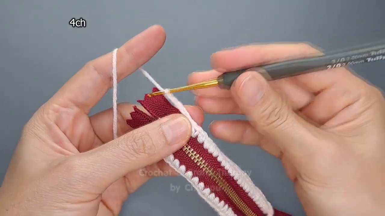 Close-up of a zipper that’s been attached unevenly, showing the contrast between tight and loose stitches.