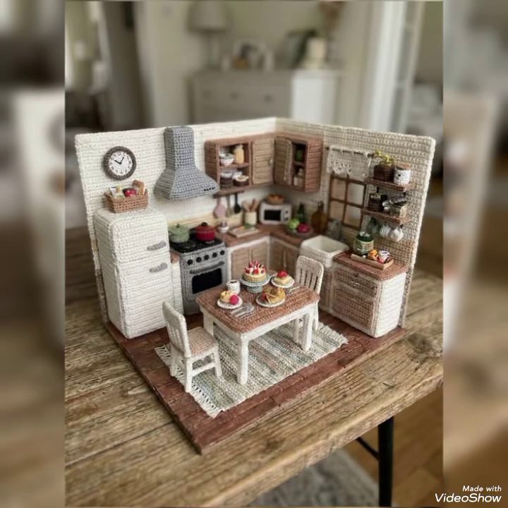 A shelf styled with a small plant, a ceramic bowl, and a framed print.